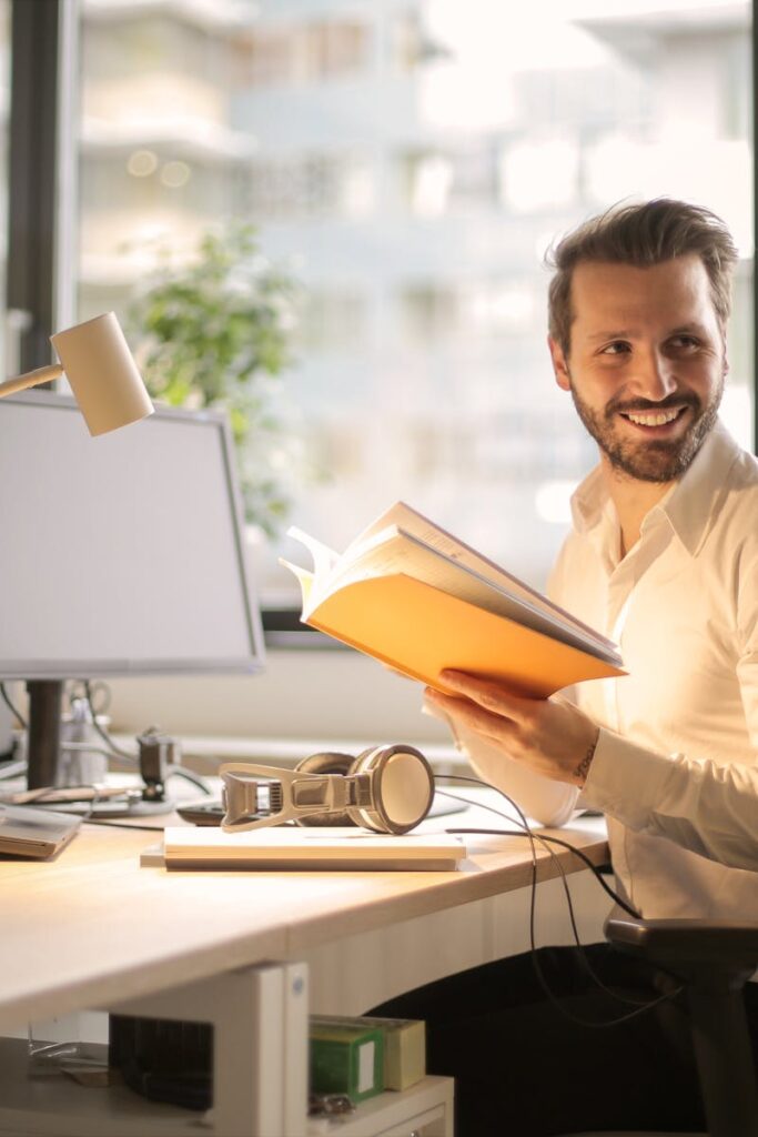 Photo of Man Holding a Book